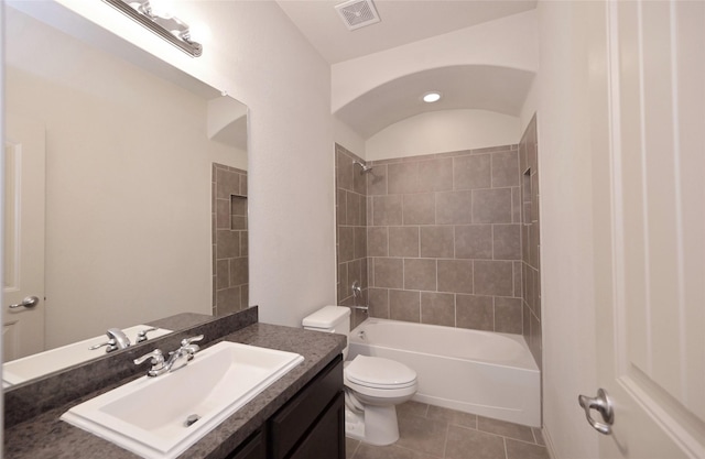 bathroom with tile patterned floors, toilet, visible vents, vanity, and tub / shower combination