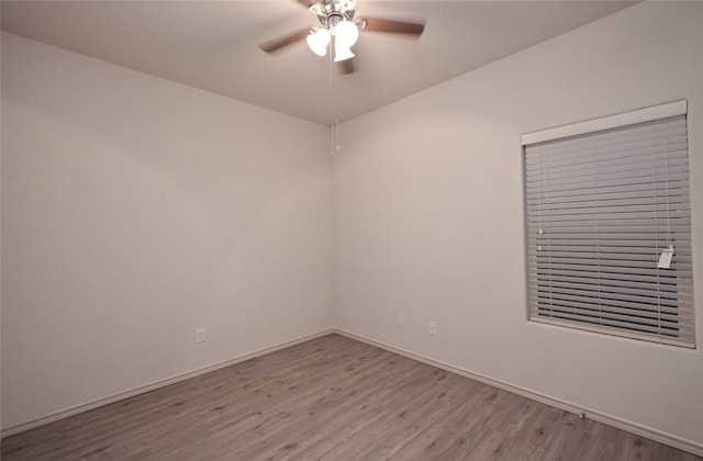 unfurnished room with ceiling fan, baseboards, and light wood finished floors
