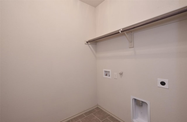clothes washing area with hookup for a washing machine, electric dryer hookup, laundry area, dark tile patterned floors, and hookup for a gas dryer