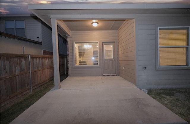 property entrance with a patio and fence