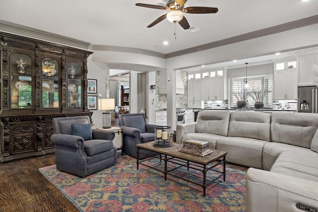 living area featuring recessed lighting, visible vents, a ceiling fan, ornamental molding, and dark wood-type flooring