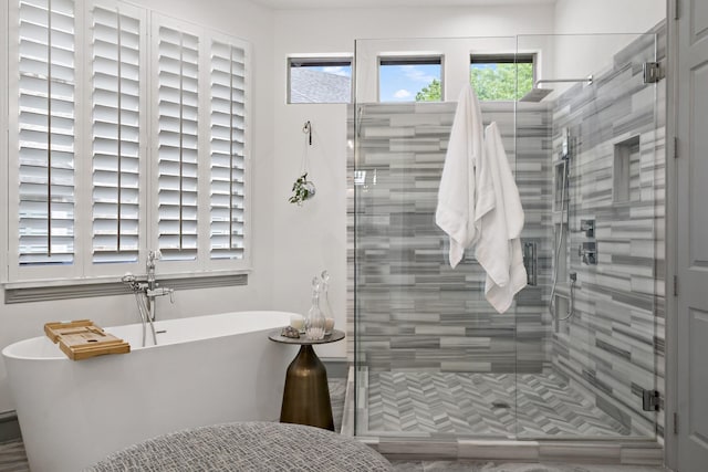 full bathroom with a soaking tub and a stall shower