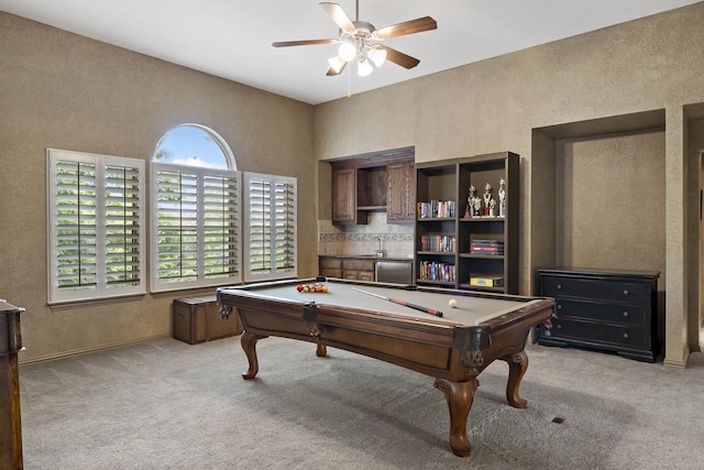 rec room with light colored carpet, a ceiling fan, a textured wall, and pool table