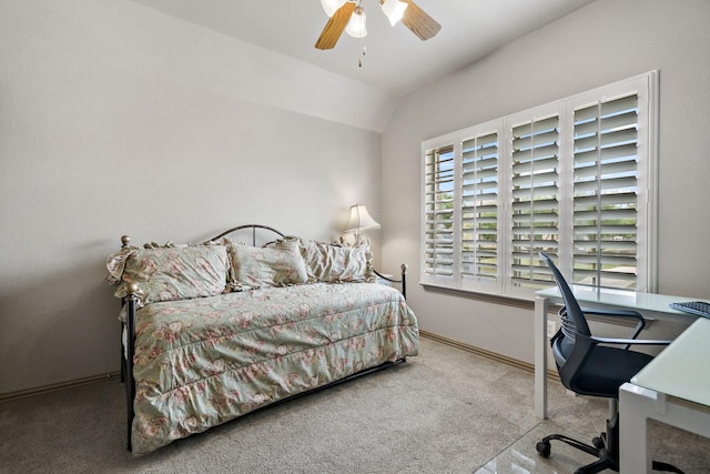 bedroom featuring lofted ceiling, baseboards, carpet flooring, and ceiling fan