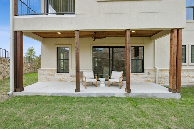 2016 Portofino Dr, Rockwall, TX 75032 - back of property with stone siding, a patio area, and a lawn