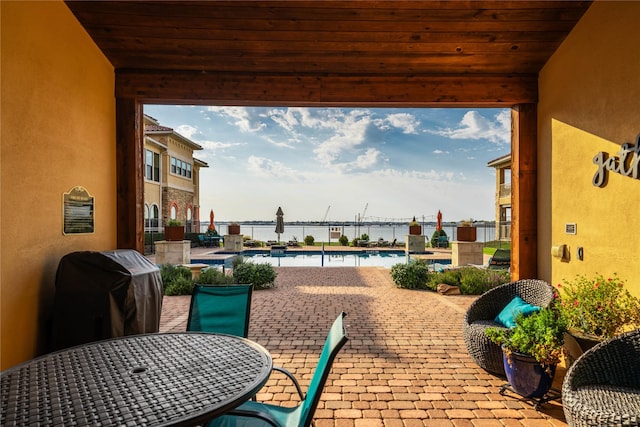 2016 Portofino Dr, Rockwall, TX 75032 - view of patio featuring a community pool, a water view, a grill, and fence