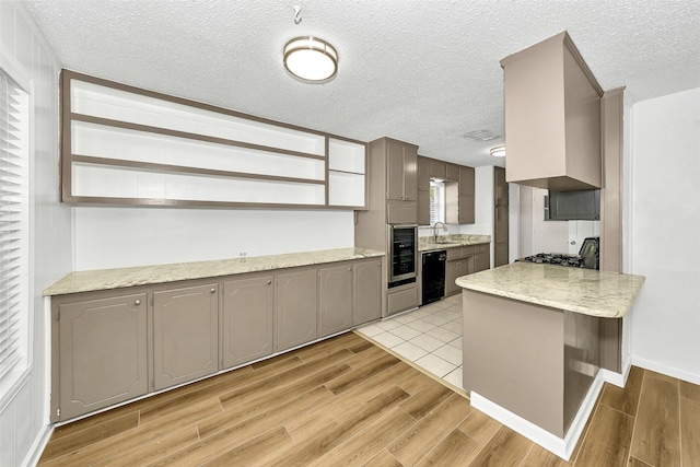 1800 W Queens Ct, Arlington, TX 76014 - kitchen featuring black dishwasher, gray cabinets, open shelves, light wood-style flooring, and a textured ceiling
