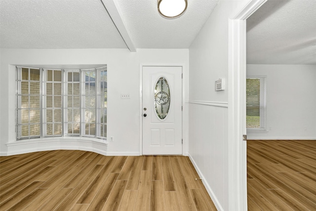 1800 W Queens Ct, Arlington, TX 76014 - foyer entrance featuring wood finished floors, a textured ceiling, beam ceiling, and baseboards