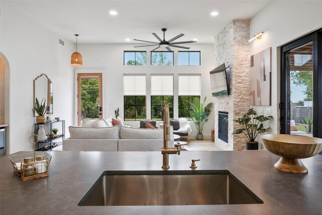 kitchen featuring open shelves, dark countertops, stainless steel gas range oven, custom range hood, and tasteful backsplash