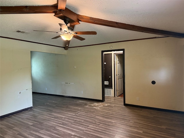 empty room with beamed ceiling, wood finished floors, visible vents, and a ceiling fan
