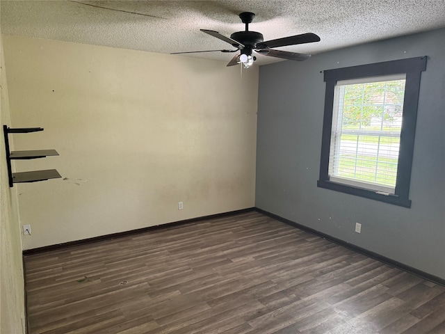spare room with ceiling fan, baseboards, wood finished floors, and a textured ceiling