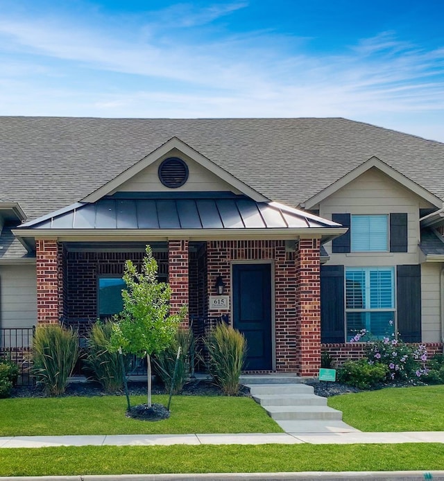 view of front of house with brick siding and a front yard