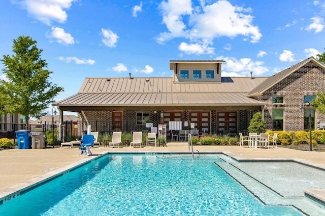 pool featuring a patio and fence