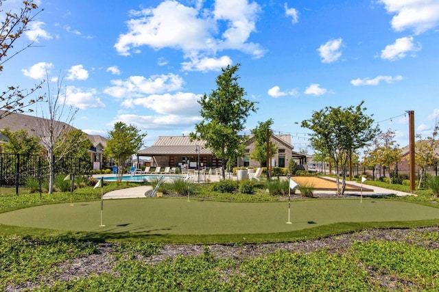 view of property's community with a swimming pool and fence