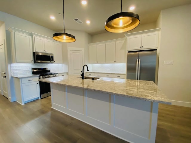 kitchen with white cabinets, stainless steel appliances, dark wood-style floors, a sink, and visible vents