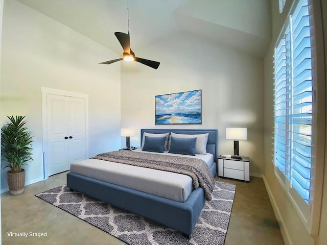 bedroom with high vaulted ceiling, a ceiling fan, a closet, concrete flooring, and baseboards
