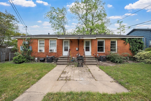 3717 Parkwood St, Waco, TX 76710 - ranch-style house with brick siding, central air condition unit, a front yard, and fence