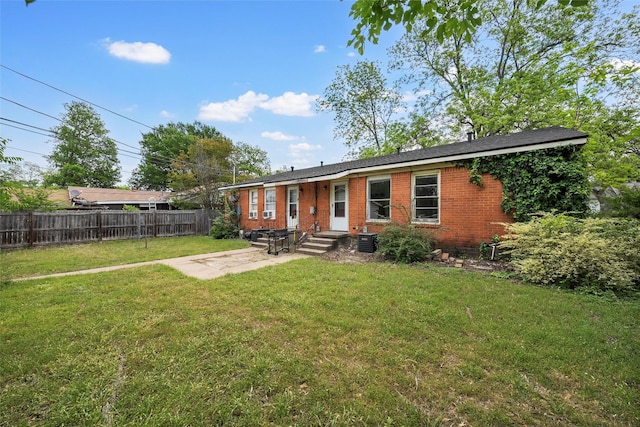 3717 Parkwood St, Waco, TX 76710 - back of house with cooling unit, fence, brick siding, a patio area, and a lawn