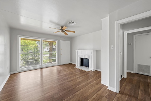 3717 Parkwood St, Waco, TX 76710 - unfurnished living room featuring a ceiling fan, a brick fireplace, wood finished floors, and visible vents