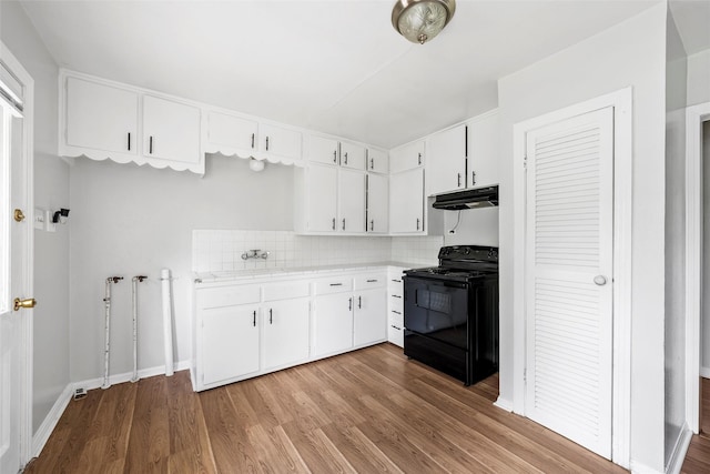 3717 Parkwood St, Waco, TX 76710 - kitchen with light countertops, under cabinet range hood, light wood-type flooring, and black electric range oven