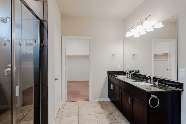 bathroom featuring a sink, double vanity, and a stall shower