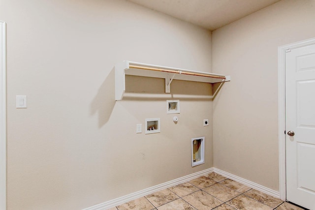 laundry area with laundry area, gas dryer hookup, baseboards, electric dryer hookup, and washer hookup
