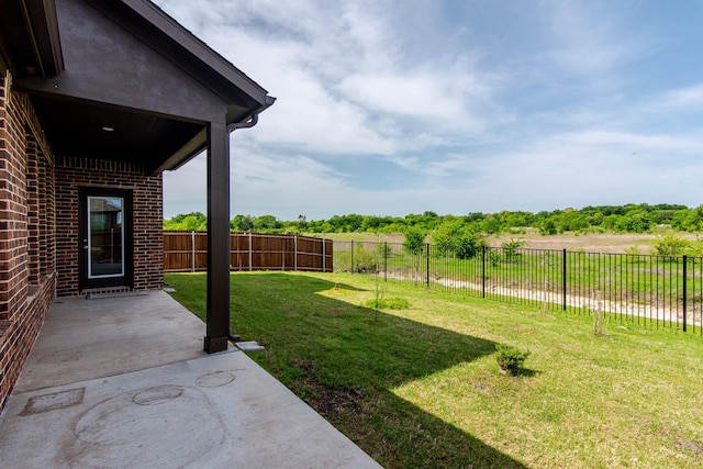 view of yard with a patio area and a fenced backyard