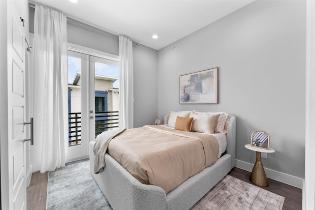 bedroom with baseboards, recessed lighting, wood finished floors, and access to exterior