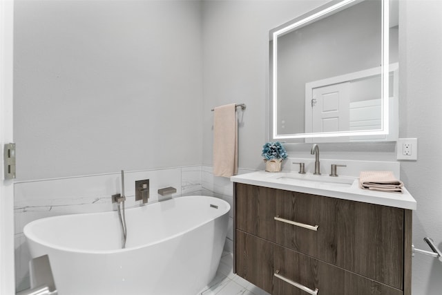 bathroom featuring tile walls, a soaking tub, and vanity