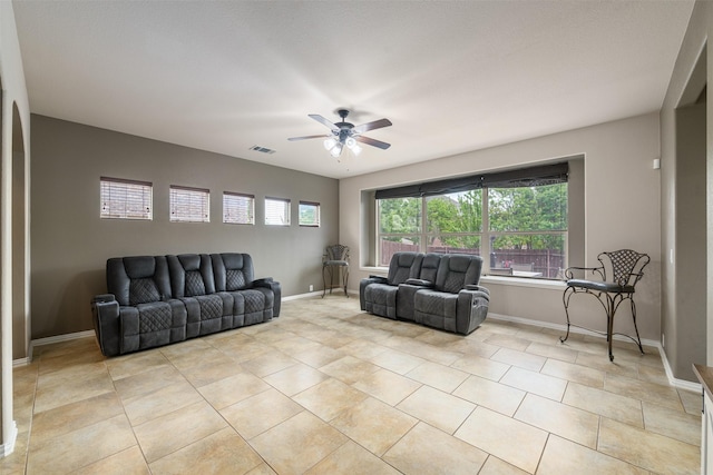 living room with ceiling fan, baseboards, light tile patterned flooring, and visible vents