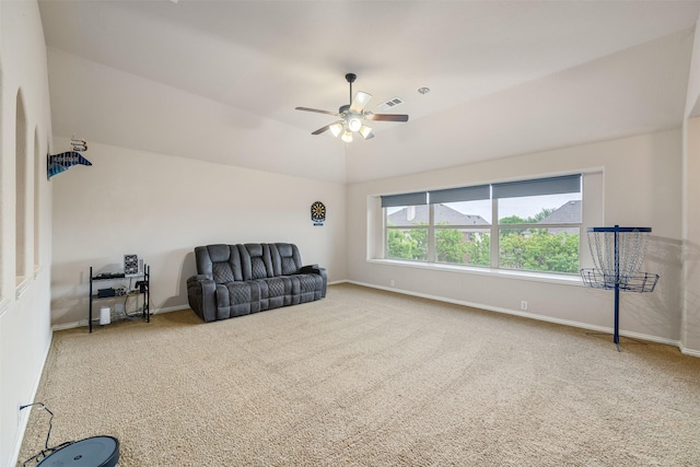 living area featuring lofted ceiling, visible vents, baseboards, carpet flooring, and ceiling fan