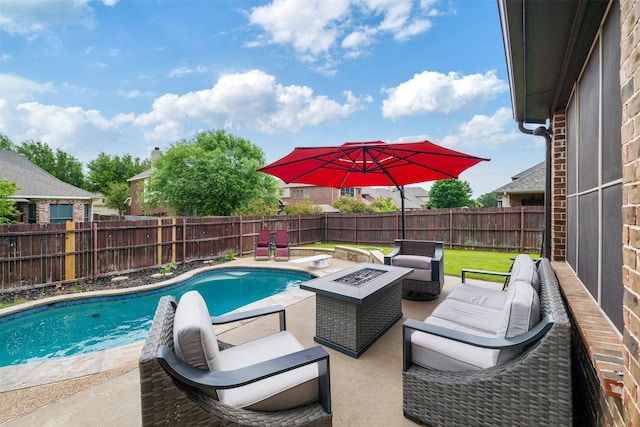 view of pool with a fenced in pool, a fenced backyard, a diving board, a patio area, and an outdoor living space with a fire pit