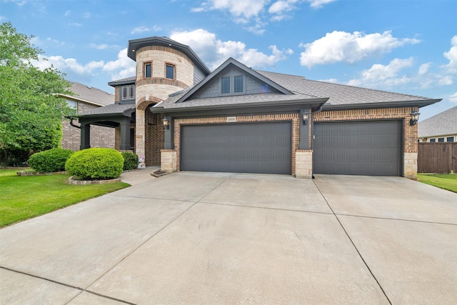 view of front facade with concrete driveway, a front lawn, brick siding, and a garage