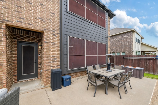 view of patio with fence and outdoor dining space