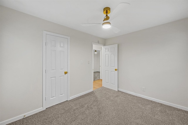 unfurnished bedroom featuring baseboards, a ceiling fan, and carpet flooring