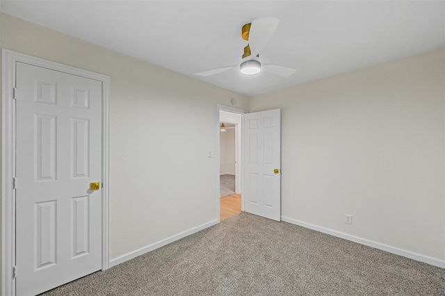 unfurnished bedroom featuring a ceiling fan, baseboards, and carpet floors