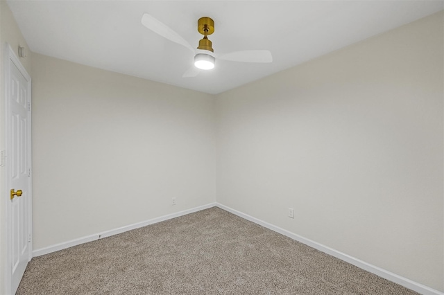carpeted empty room featuring baseboards and ceiling fan