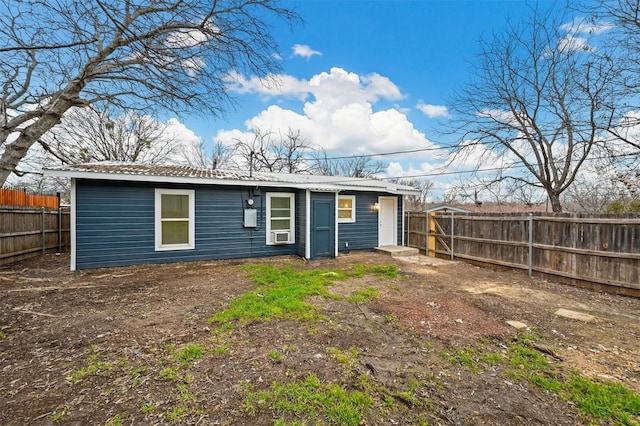 back of property with a fenced backyard