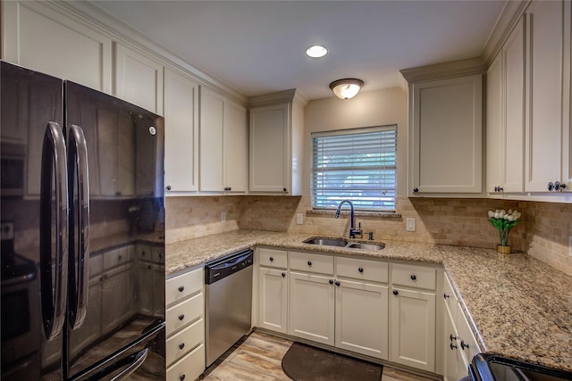 kitchen featuring a sink, recessed lighting, decorative backsplash, light stone countertops, and appliances with stainless steel finishes