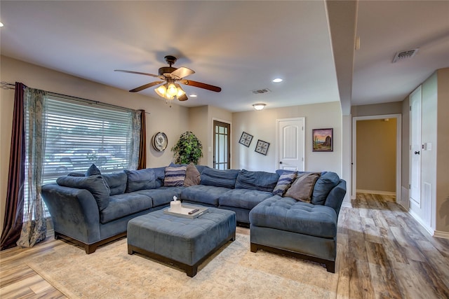 living room featuring recessed lighting, light wood-style flooring, visible vents, and a ceiling fan