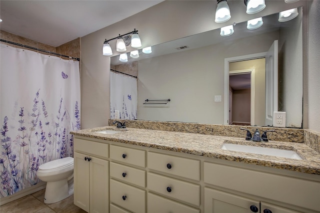 full bathroom with tile patterned flooring, a sink, visible vents, and double vanity