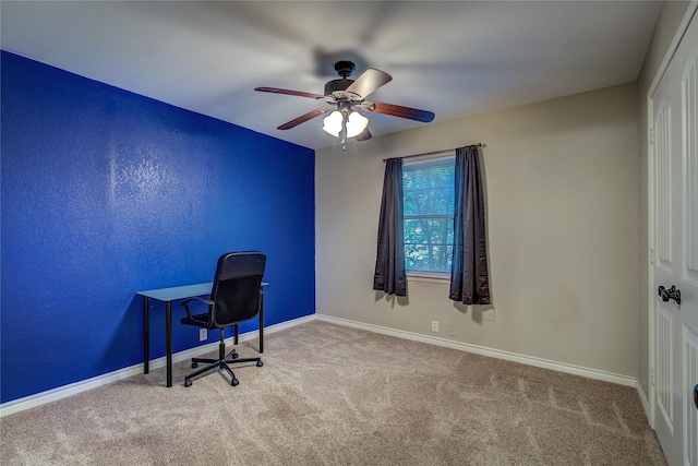 unfurnished office featuring baseboards, carpet, and ceiling fan