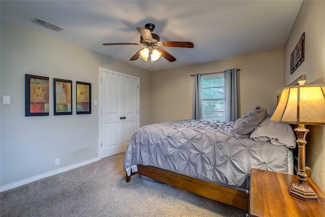 bedroom featuring visible vents, a ceiling fan, a closet, baseboards, and carpet flooring