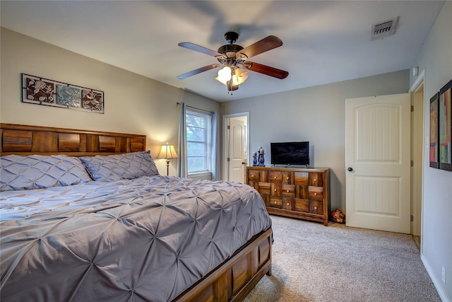 bedroom with ceiling fan, visible vents, and light colored carpet