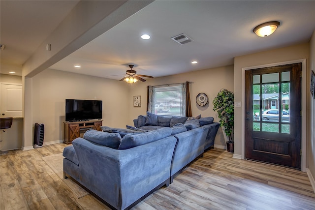 living room with light wood-style flooring, a wealth of natural light, and recessed lighting