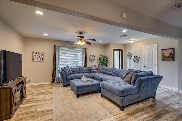 living room with ceiling fan, baseboards, light wood finished floors, and visible vents