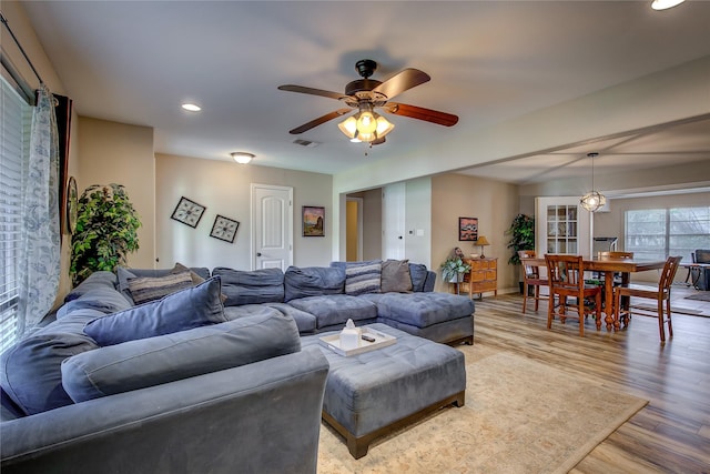 living area featuring ceiling fan, light wood-style floors, visible vents, and recessed lighting