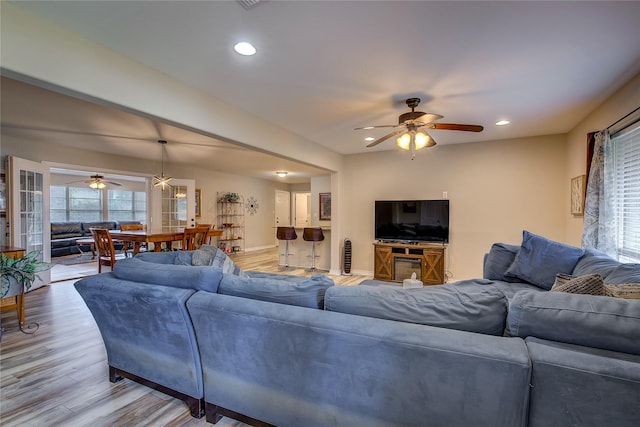 living area with ceiling fan, recessed lighting, and light wood-style flooring