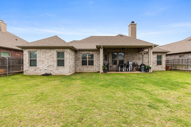 10009 Wildberry Dr, Waco, TX 76712 - rear view of house with a chimney, a patio, brick siding, and a fenced backyard