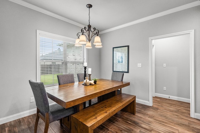 10009 Wildberry Dr, Waco, TX 76712 - dining area featuring a chandelier, crown molding, baseboards, and wood finished floors
